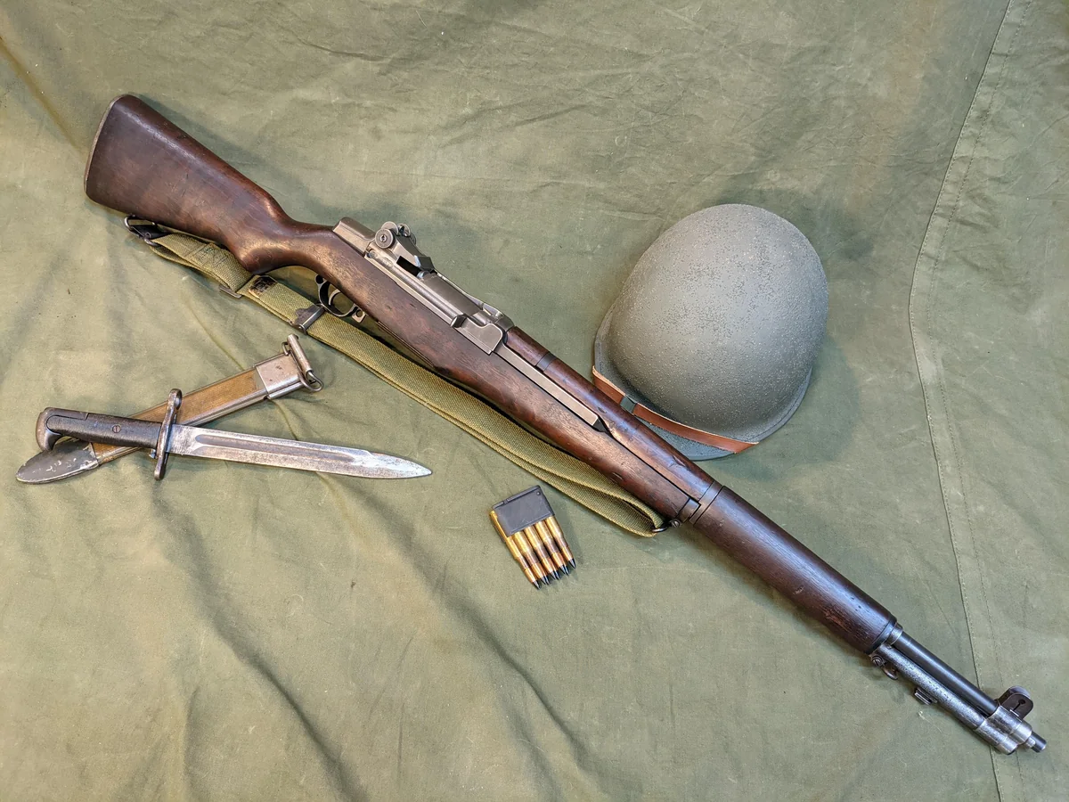 M1 Garand rifle with M1 helmet, M1905 bayonet, and 8-round en-bloc clip