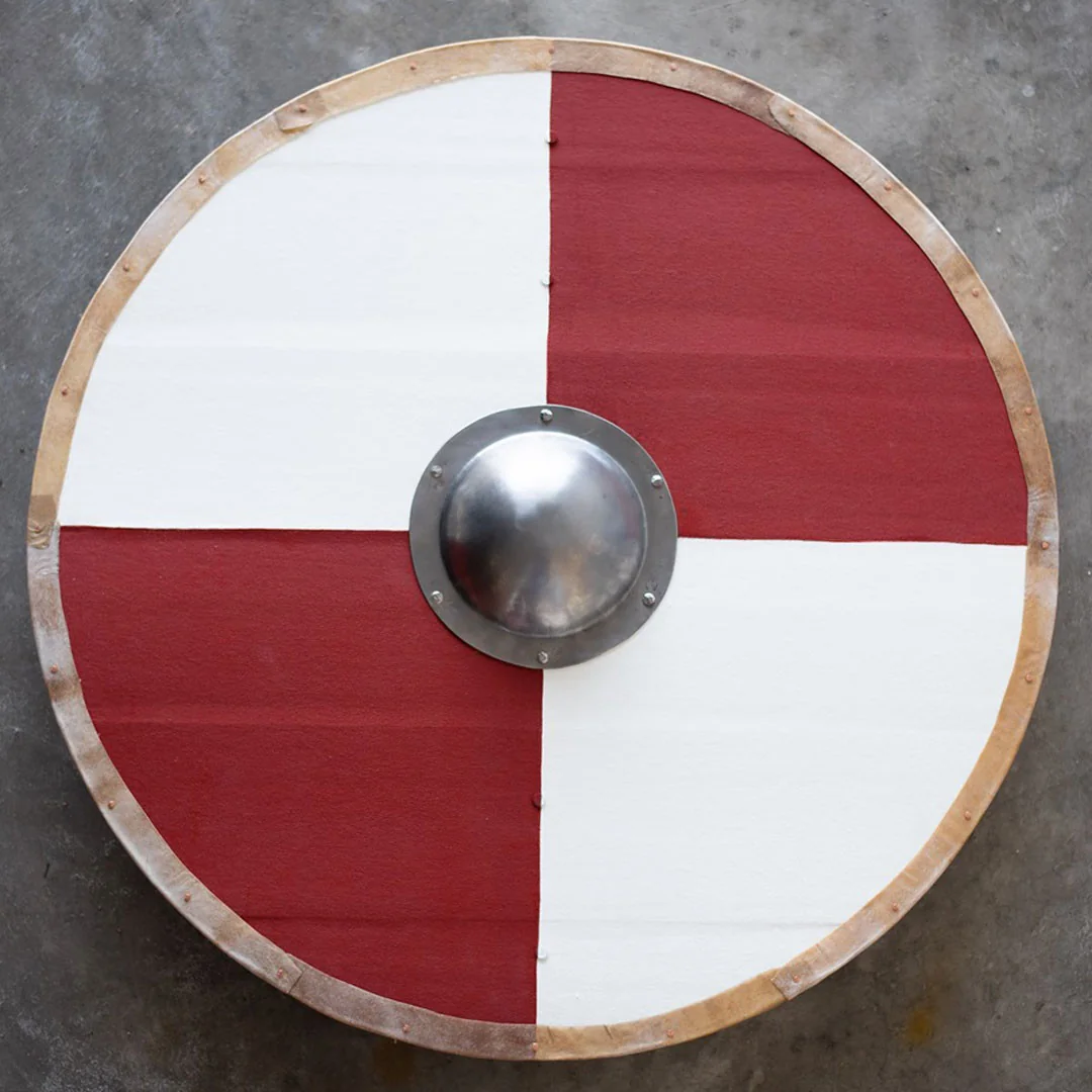 Reconstructed Viking-age round wooden shield with central iron boss and painted face